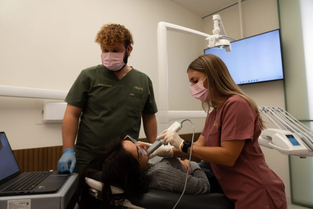 Doctor e higienista tratando a paciente en Clínica dental en Elda
